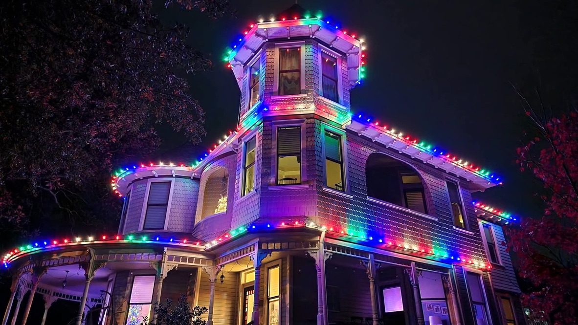 Home with festive multicolor roofline lighting